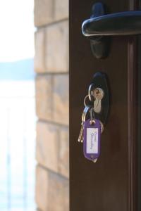 a lock on a door with a tag on it at House on the beach in Kotor