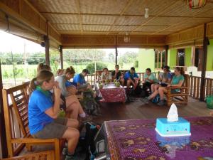 a group of people sitting around a table at AMBOW Homestay Jungle Trekking & Village Tour in Bukit Lawang