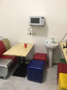 a room with a table and a sink and a microwave at Hostel Railway Kiev in Kyiv