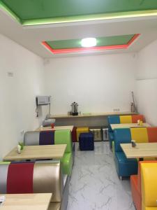 a dining room with colorful tables and chairs at Hostel Railway Kiev in Kyiv