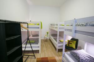 A bed or beds in a room at Friends Hostel & Apartments