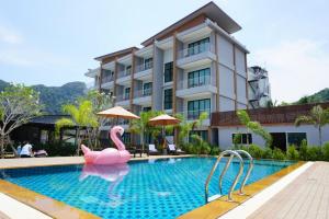 a swimming pool with a pink flamingo in front of a building at Aonang Sea Valley Resort in Ao Nang Beach
