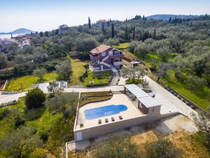 an aerial view of a house with a swimming pool at Little Dream in Poljana