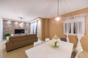 a living room with a couch and a table at Little Dream in Poljana