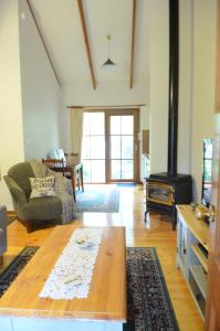 a living room with a table and a wood stove at Glenview Retreat Luxury Accommodation in Emerald