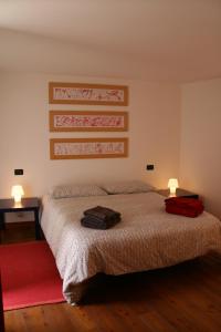 a bedroom with a bed with two bags on it at Casa del Gelsomino in Stresa