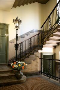 a staircase leading up to a balcony with a fire hydrant at Hotel Palladio in Milan