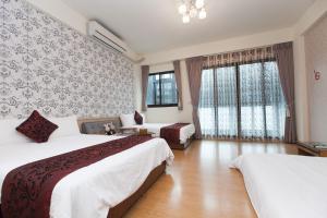 Postel nebo postele na pokoji v ubytování Four Seasons Homestay