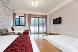 TV a/nebo společenská místnost v ubytování Four Seasons Homestay