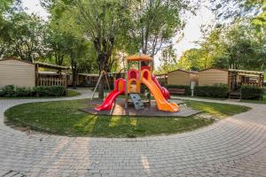 a playground with a slide in a park at Hotel La Diga Altomincio in Valeggio sul Mincio
