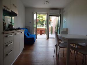 a kitchen with a table and a dining room at S127 - Sirolo, nuovissimo monolocale con terrazzo in Sirolo