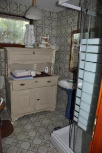 a bathroom with a sink and a vanity with a mirror at Apartments MM in Muta