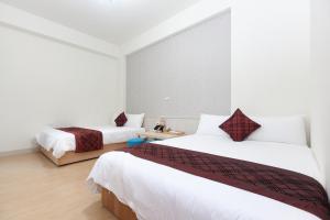 Postel nebo postele na pokoji v ubytování Four Seasons Homestay