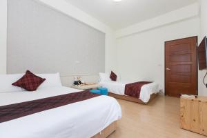 Postel nebo postele na pokoji v ubytování Four Seasons Homestay