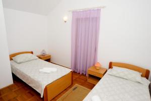 Una cama o camas en una habitación de Guest House Krševan