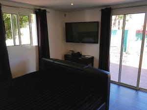 a living room with a couch and a flat screen tv at 142B Dehesa Baja in Alhaurín el Grande