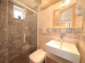 a bathroom with a sink and a toilet and a mirror at Casa Vacanze Bel sole in Monopoli