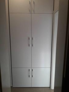 a white closet with white cabinets in a room at Apartman Senjak in Pirot