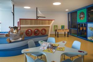 a kindergarten classroom with tables and a pirate themed room at Falkensteiner Hotel Park Punat in Punat