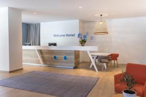 an office with a white desk and a table at Falkensteiner Hotel Park Punat in Punat