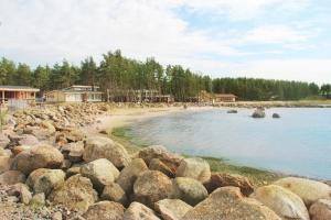 a group of rocks on the shore of a beach at Okunevaya Holiday Park in Ozerki