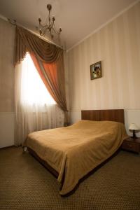 Postel nebo postele na pokoji v ubytování Magnat Lux Hotel