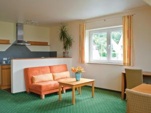 a living room with a couch and a table at Berggasthof Hotel Igelwirt in Schnaittach