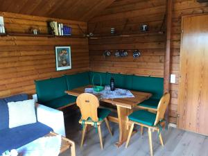 a dining room with a table and chairs in a cabin at Ferienhaus Sauerland in Herscheid