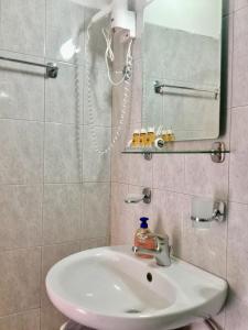 a bathroom with a sink and a mirror at Platanos Rooms in Anopoli Sfakion