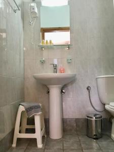 a bathroom with a sink and a toilet at Platanos Rooms in Anopoli Sfakion