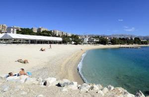 a beach with people laying on the sand and the water at Luxury Apartment Marko in Split