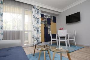 a living room with a table and chairs at M&N Central Apartment in Plovdiv