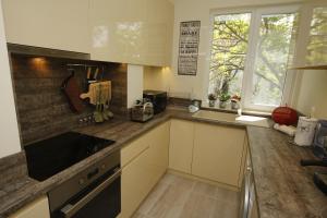 a kitchen with white cabinets and a counter top at M&N Central Apartment in Plovdiv