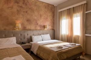 Postel nebo postele na pokoji v ubytování Apollon Hotel