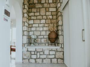 a brick wall with a vase on a shelf at PanMari in Paphos +172 photos