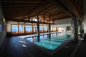 a large indoor swimming pool in a building at LES SAISIES - LA PERLE DES ALPES in Les Saisies