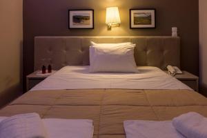 Postel nebo postele na pokoji v ubytování Apollon Hotel