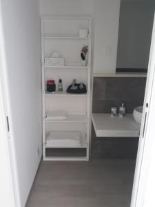 a white closet with white shelves in a bathroom at Settimo Cielo in Florence