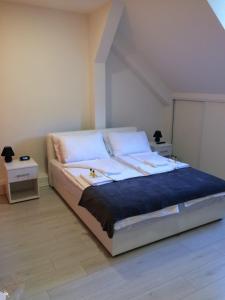 a bedroom with a large bed with white pillows at Apartment Vatra in Sarajevo