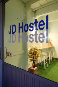 a jd hospital sign in the window of a store at JD hostel in Phra Nakhon Si Ayutthaya