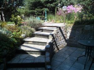 a set of stone steps in a garden at Teltow Ferienwohnung in Teltow