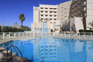 a large swimming pool in front of a building at Al Rabea Hotel in Najran