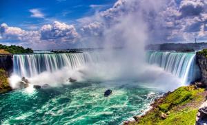 vista su una cascata con una barca in acqua di Shiva's Travelers Lodge a Niagara Falls