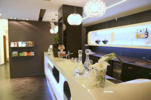 a kitchen with a counter with glasses and flowers on it at Hotel Carla in Levanto