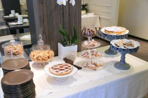 a table with various pastries and desserts on it at Hotel Carla in Levanto