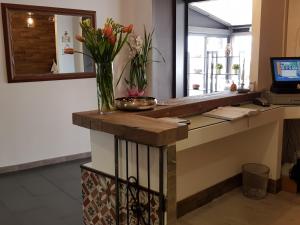 an office with a desk with a vase of flowers on it at Vela Bianca H & R in Diano Marina