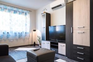 A television and/or entertainment centre at Alma Apartman