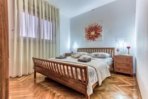 a bedroom with a large bed and a window at Sunny apartment Vesna in Split