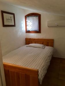 Giường trong phòng chung tại L'Olivastro