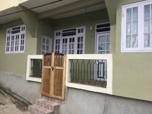 a house with a gate and a window at Smriya Homestay in Darjeeling